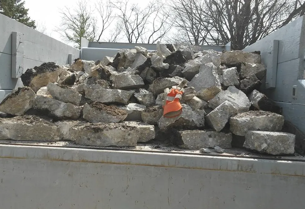 Broken concrete chunks loaded in a truck bed for haul-off